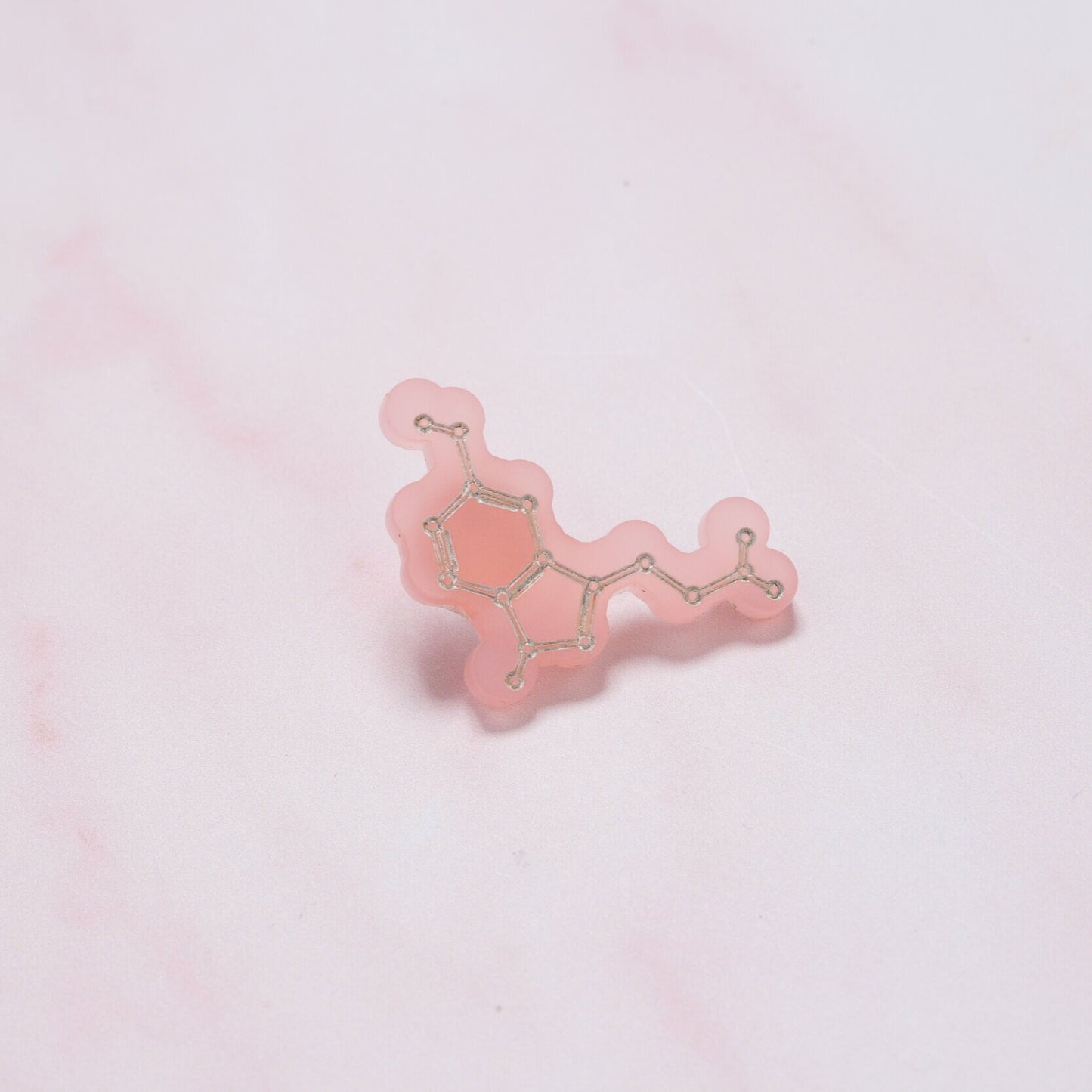 Serotonin molecule pin badge: 'Happiness chemical'